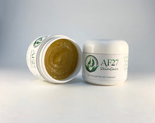Load image into Gallery viewer, 2 Jars of AF27 Peppermint Salve Extra Strength Psoriasis Treatment for moderate to severe cases of psoriasis and eczema, 1 jar shown on it's side with the lid off.